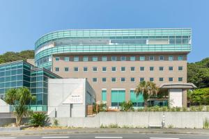 a large office building with a glass at Hayama Umino Hotel in Hayama