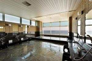a large bathroom with a view of the ocean at Hayama Umino Hotel in Hayama