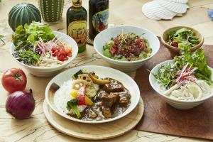 a table topped with bowls of food and vegetables at Hayama Umino Hotel in Hayama