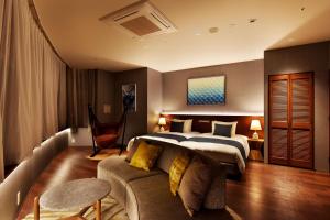 a hotel room with a bed and a couch at Hayama Umino Hotel in Hayama
