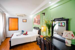 Postel nebo postele na pokoji v ubytování Hanoi Sunshine Hotel