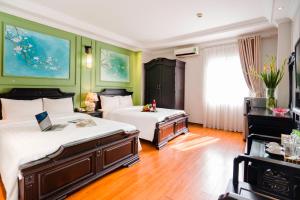 Postel nebo postele na pokoji v ubytování Hanoi Sunshine Hotel