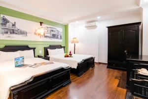 Postel nebo postele na pokoji v ubytování Hanoi Sunshine Hotel