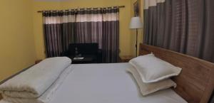 Letto o letti in una camera di DRAKON NEST HOMESTAY