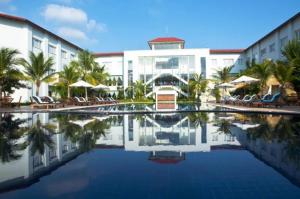 a hotel with a pool in front of a building at EG Paradise Angkor Villa Hotel in Siem Reap