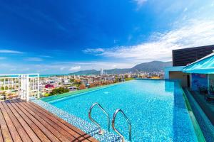 a swimming pool on the roof of a building at Triple L Hotel Patong Beach Phuket in Patong Beach