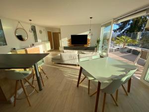 a living room with a glass table and chairs at Lausanne holidays in Renens