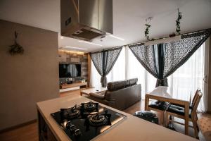 a kitchen and living room with a stove top oven at The Stay Christmas in Jeju