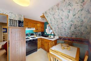 a kitchen with wooden cabinets and a counter top at Provincetown Bliss in Provincetown
