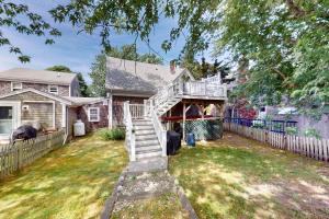 a house with a white staircase in a yard at Provincetown Bliss in Provincetown