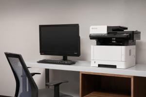 a computer sitting on top of a desk with a printer at Holiday Inn Express & Suites by IHG Chambersburg by IHG in Chambersburg