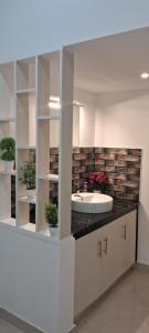 a bathroom with a sink and a counter with plants at Rockland Holidays in Ramakkalmedu