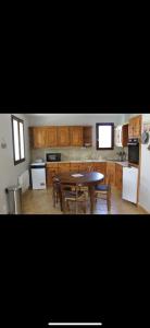 a kitchen with a table and chairs in it at Maison de vacances in Saint-Trojan-les-Bains