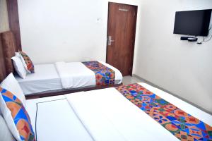 Postel nebo postele na pokoji v ubytování Hotel Pride Inn
