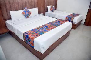 Postel nebo postele na pokoji v ubytování Hotel Pride Inn
