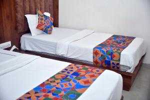 Postel nebo postele na pokoji v ubytování Hotel Pride Inn