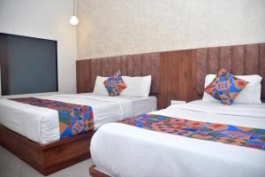 Postel nebo postele na pokoji v ubytování Hotel Pride Inn