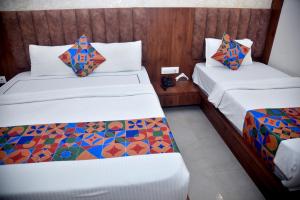 Postel nebo postele na pokoji v ubytování Hotel Pride Inn