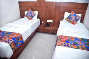 Postel nebo postele na pokoji v ubytování Hotel Pride Inn