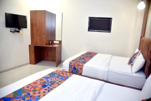 Postel nebo postele na pokoji v ubytování Hotel Pride Inn