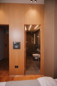 a bathroom with a door leading to a toilet at Hotel Ehden in Ehden