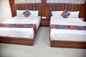 Postel nebo postele na pokoji v ubytování Hotel Pride Inn