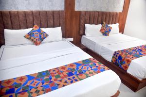 Postel nebo postele na pokoji v ubytování Hotel Pride Inn