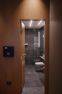 a bathroom with a toilet and a glass shower at Hotel Ehden in Ehden