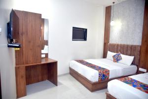 Postel nebo postele na pokoji v ubytování Hotel Pride Inn