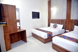 Postel nebo postele na pokoji v ubytování Hotel Pride Inn