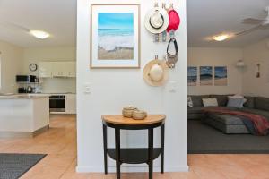 a kitchen and living room with a table in a room at Lovely Pet Friendly Beach House in Hawks Nest