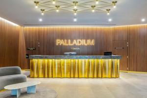 a lobby with a gold wall with a paladin sign at Sophisticated Designer Condo w City & Bay Views in Melbourne +49 photos