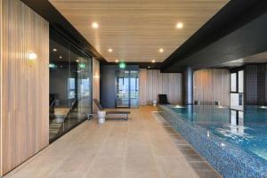 a pool in the middle of a building at Sophisticated Designer Condo w City & Bay Views in Melbourne