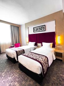 Letto o letti in una camera di Batam City Hotel
