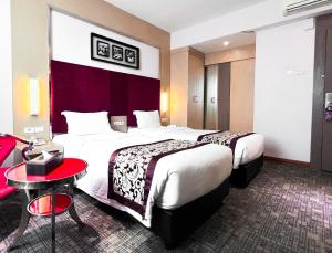 Letto o letti in una camera di Batam City Hotel