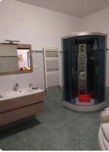 a bathroom with a shower and a sink and a mirror at Casa Giulia in Genoa
