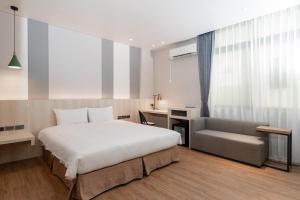 Postel nebo postele na pokoji v ubytování Fu Hsiang Hotel