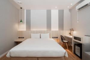 Postel nebo postele na pokoji v ubytování Fu Hsiang Hotel