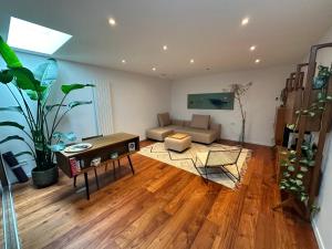 a living room with a couch and a table at Studio Senang in Nijmegen