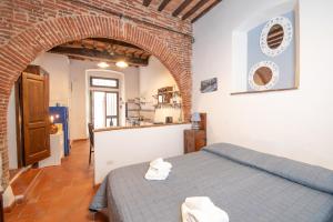 En eller flere senge i et værelse på Piombino Apartments - Casa Loriano