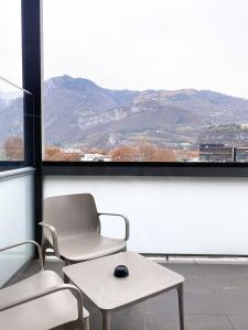 a room with two chairs and a table and a window at La Villa - Luxury Guest House in Trento