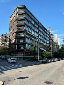 a tall building with cars parked in front of it at Unique apartment on the prestige address in Helsinki