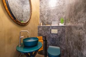 a bathroom with a blue sink and a mirror at Casa Bonaparte in Pula