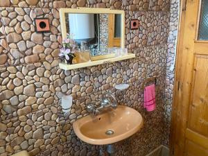 a bathroom with a sink and a stone wall at Niya Guest House in Beli Iskar +53 photos