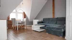 a living room with a couch and a table at Vintageapartment in Sopot