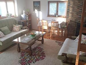 a living room with a couch and a coffee table at Misevici vikendica in Sarajevo