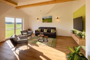 una sala de estar con un sofá y una mesa en Ferienwohnung Egg-Hof, en Bad Grönenbach