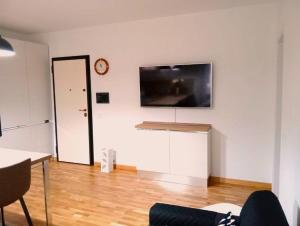 a living room with a flat screen tv on a wall at La Maison de Monique in Policoro