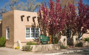 a building with a sign in front of it at El Farolito B&B Inn in Santa Fe
