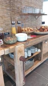 a table with plates of food and bread on it at Les Jardins de L'Ocean - Climatisé in Biscarrosse-Plage